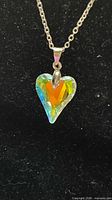 Close-up of crystal heart pendant on chain