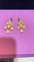 Front view of both chandelier earrings showing rhinestones and yellow teardrop dangles