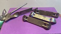 All four metal openers on purple background
