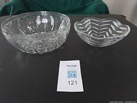 Large and medium clear glass serving bowls side by side