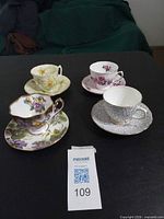 All four teacup and saucer pairs displayed together