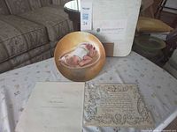 Front view of plate, booklet, certificate, box
