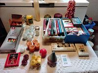 Tabletop view of entire assortment of assorted new candles