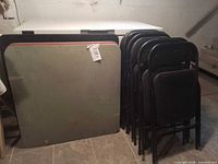 All three tables stacked with nine folding chairs