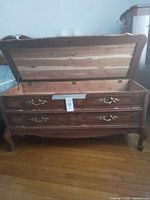 Chest open showing cedar interior, faux drawers and hardware visible