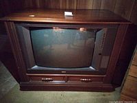 Front view of RCA console CRT television showing screen, controls, and cabinet
