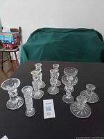 Group of crystal candle holders and vase on table