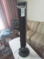 Full view of Noma tower fan standing on base