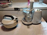 Food processor and kettle side by side on countertop