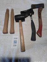 Group view of two hatchets, one rubber mallet and two wooden hammer handles