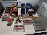 Overall view showing bins, organizers, fasteners, hand tools and hardware packaging on table