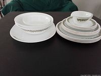 Two stacks of Corning Spring Blossom dishes including plates, bowls and cup