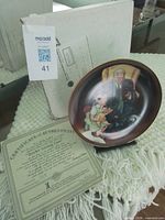 Plate on stand with COA and box visible