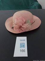 Top view of peach ladies hat with floral decoration