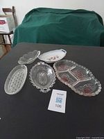 Five assorted pickle dishes displayed on table