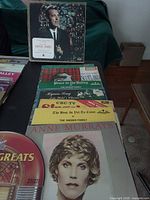 Front view showing Tennessee Ernie Ford LP on stand with stack of additional albums beneath including Anne Murray and others