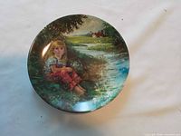 Front view of decorative plate featuring child by stream scene