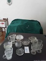 Group shot of glass serving items and partial view of plastic bowls