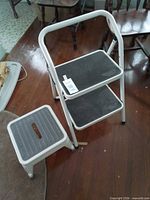 Two step stools standing: folding two-step and single-step