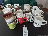 All mugs arranged on table showing designs and condition