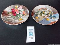 Both W. L. George floral plates side by side showing overall design and size reference