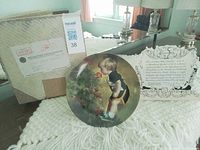 Front of plate, certificate, shipping box visible