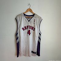 Full front view of jersey on hanger showing team name, number, side panels and Reebok tag