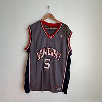 Full front view of grey New Jersey Nets #5 Jason Kidd Nike jersey on hanger