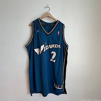 Full front view of blue Wizards John Wall #2 jersey on hanger
