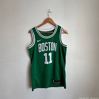 Front view of green Boston Celtics #11 jersey on hanger