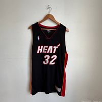 Full front view of black Miami Heat #32 jersey on hanger