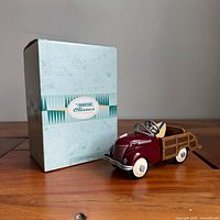 Model posed beside original box showing overall appearance