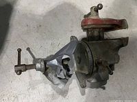 Top view of cast iron bench vise showing swivel base, duct-taped repair, rust