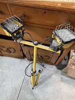 Full view of dual-head work light on yellow tripod