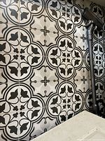 Installed example showing black and white ornamental pattern tiles