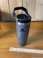 full view of tumbler showing color, logo, lid with handle