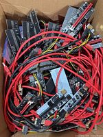 Box full of riser boards and red cables