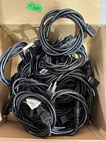 Box of coiled black power cords