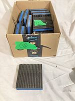 Box containing multiple DiversiTech pads with visible blue foam edges