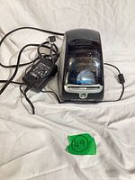 Printer with attached USB cable and power adapter