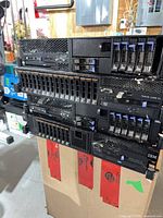 Stack of four IBM System x3690 X5 servers showing front hot-swap drive bays and power supply slots