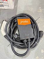 Full charger coiled showing handle, cable and control box