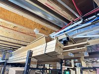 Stack of dimensional lumber on shelf showing variety of sizes