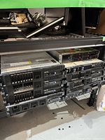 Rack shelf holding eight 2U servers with mixed drive caddies visible