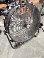 Full view of fan showing drum, guard, frame and wheels