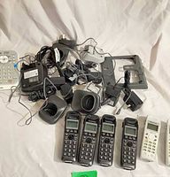 Overview of entire lot showing handsets, cradles, cables