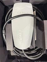 Tesla Wall Connector charger coiled in box