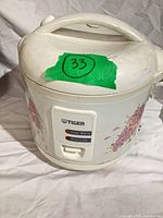 Front view showing Tiger logo, control panel, floral design