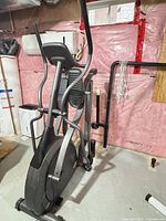 Full view of Vision Fitness X6200 elliptical showing frame, flywheel, pedals and handlebars