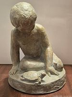 Front view showing child and turtle on circular base